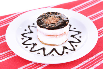 Sweet cake with chocolate on plate on table close-up
