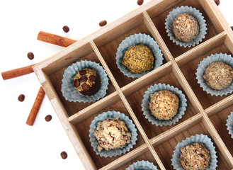 Chocolate candies in wooden  box isolated on white