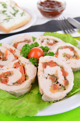 Delicious chicken roll on plate on table close-up