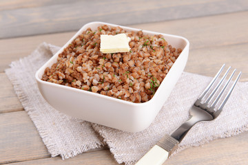 Boiled buckwheat in bowl on table close-up