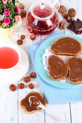 Bread with sweet chocolate hazelnut spread on plate on table