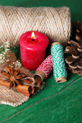 Composition with natural bump, candle, thread, cinnamon sticks