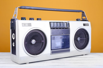 Obraz premium Retro cassette stereo recorder on table on yellow background