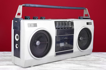 Obraz premium Retro cassette stereo recorder on table on red background