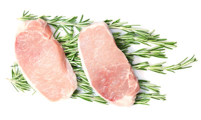 Raw meat steak with herbs isolated on white
