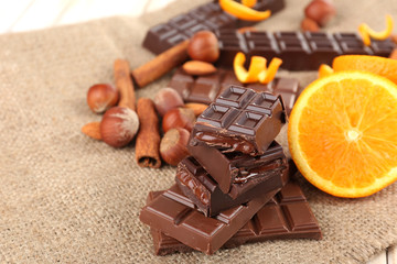 Chocolate, orange and nuts on table