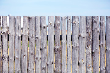 Wooden fence on sky background