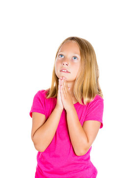 Praying teenager girl looking up isolated on white background 