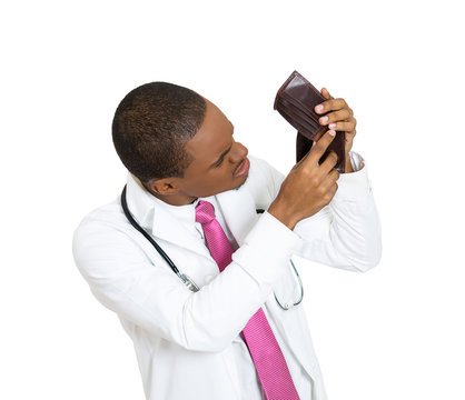 Portrait healthcare professional with empty wallet. Broke doctor