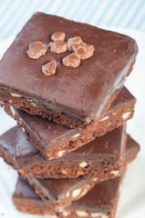 a pile of nutty milk chocolate coated brownies