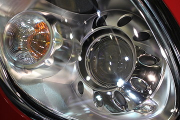 detail of front headlight on car.