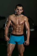 Fototapeta na wymiar Healthy Young Man Standing In Gym