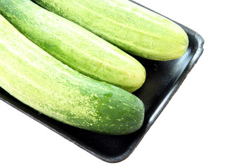 cucumber in black tray container isolated.