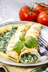 Mediterranean cuisine: crepes stuffed with cheese and spinach