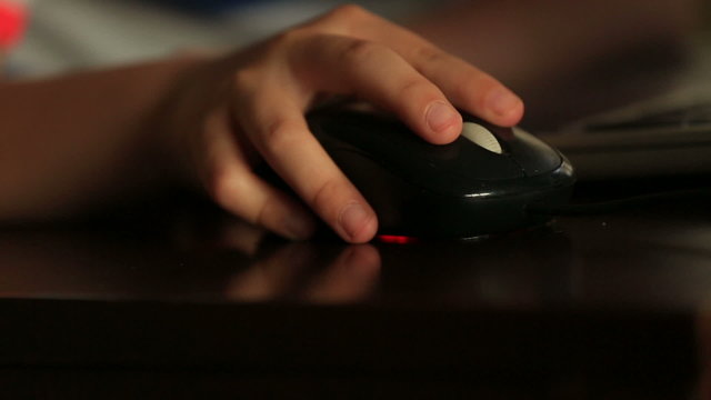 little child hand using a computer mouse
