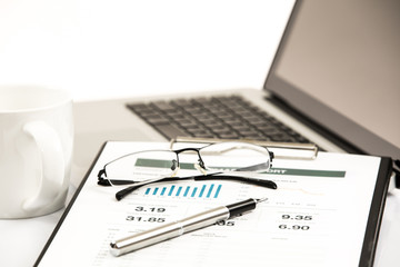 Businessman analyzing investment charts on laptop