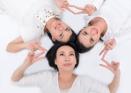 Lively family lying on the floor with heads together