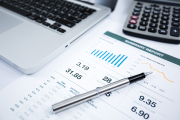 Businessman analyzing investment charts with laptop