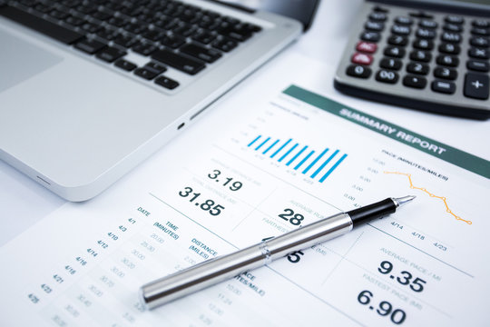 Businessman analyzing investment charts with laptop