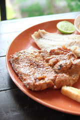 grilled pork steak with french fries and toast.