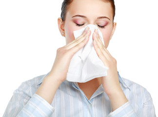 Sick woman blowing her nose, white background