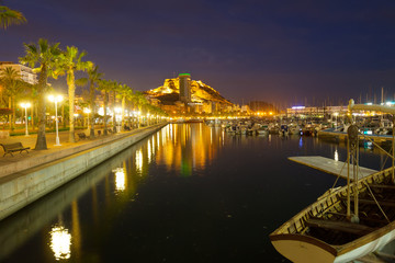 Fototapeta na wymiar Port with yachts and embankment in night. Alicante