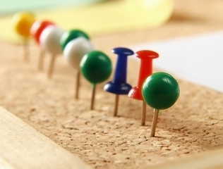 Close up of three push pins.