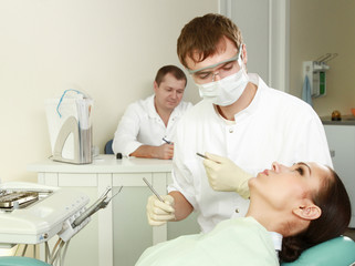 Young woman with dentist in a dental surgery
