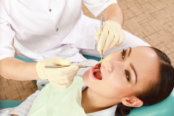 Obraz na płótnie Canvas Young woman with dentist in a dental surgery.