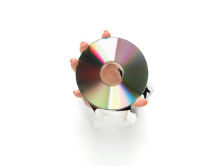 hand holding a compact disc on white background.