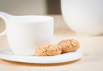 cup of espresso coffee and biscuit near sugar bowl