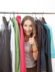 Young woman near rack with hangers