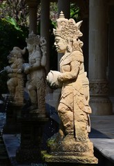 Statue de divinit&eacute; et fontaine dans un jardin de Bali