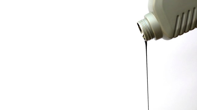 Oil Dripping From Container On White