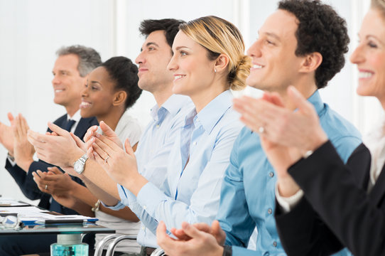 Businesspeople Clapping In Office