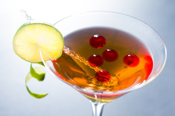 Cocktail with whisky and raspberry sphere