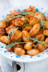 Traditional italian gnocchi with tomato sauce, close-up