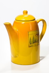 Yellow teapot on a white background