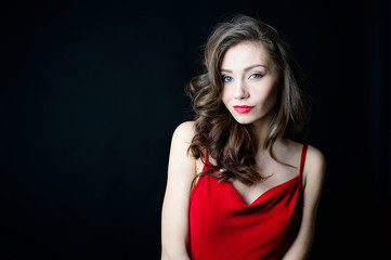 Beautiful young woman in red dress with evening make-up