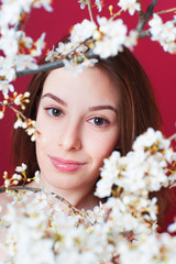 Portrait of beautiful girl with blooming branch