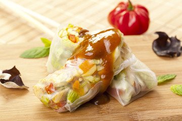Portion of spring rolls on a bamboo board