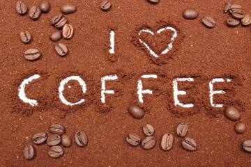 Coffee word written on ground coffee and grains