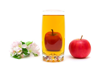 blossoms of apple, a glass of juice and apple on a white backgro