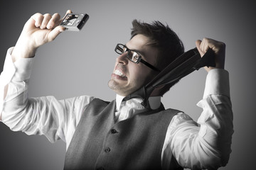 Laughing young man makes a selfie with a compact camera