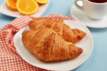 Croissants, tea and orange juice for breakfast