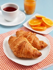Croissants, tea and orange juice for breakfast