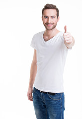 Young happy man with thumbs up sign in casuals.