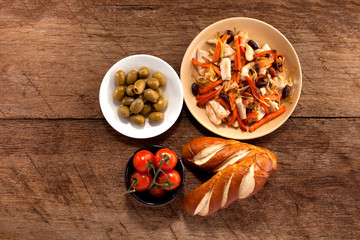Dish with meat, tomato, bread and olives