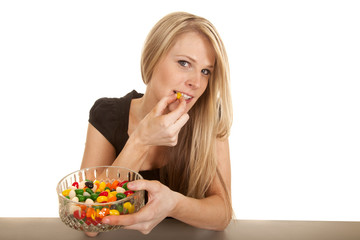woman eating jellybeans bite yellow one