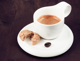 cup of italian espresso coffee and biscuit near coffee bean
